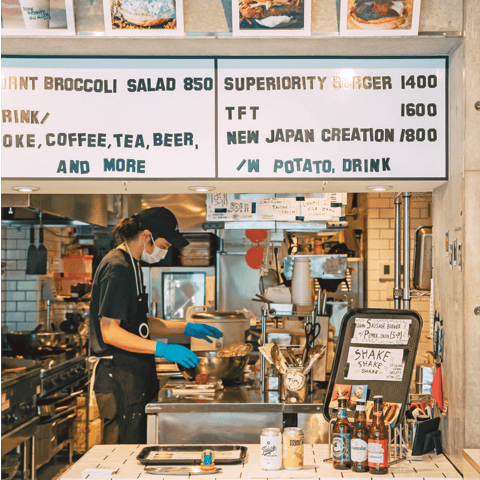 A view of a person behind a hamburger store counter