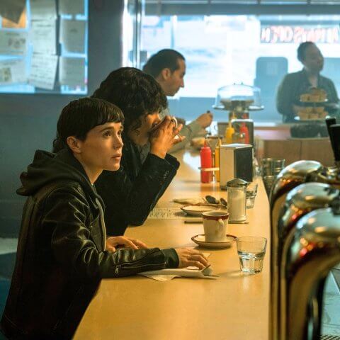 A man sits at a diner counter