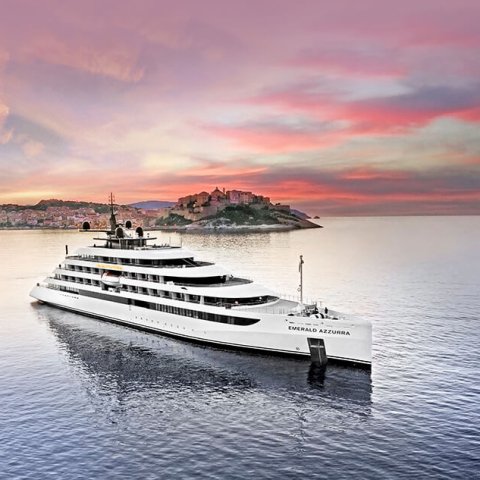 white cruise ship on water at sunset