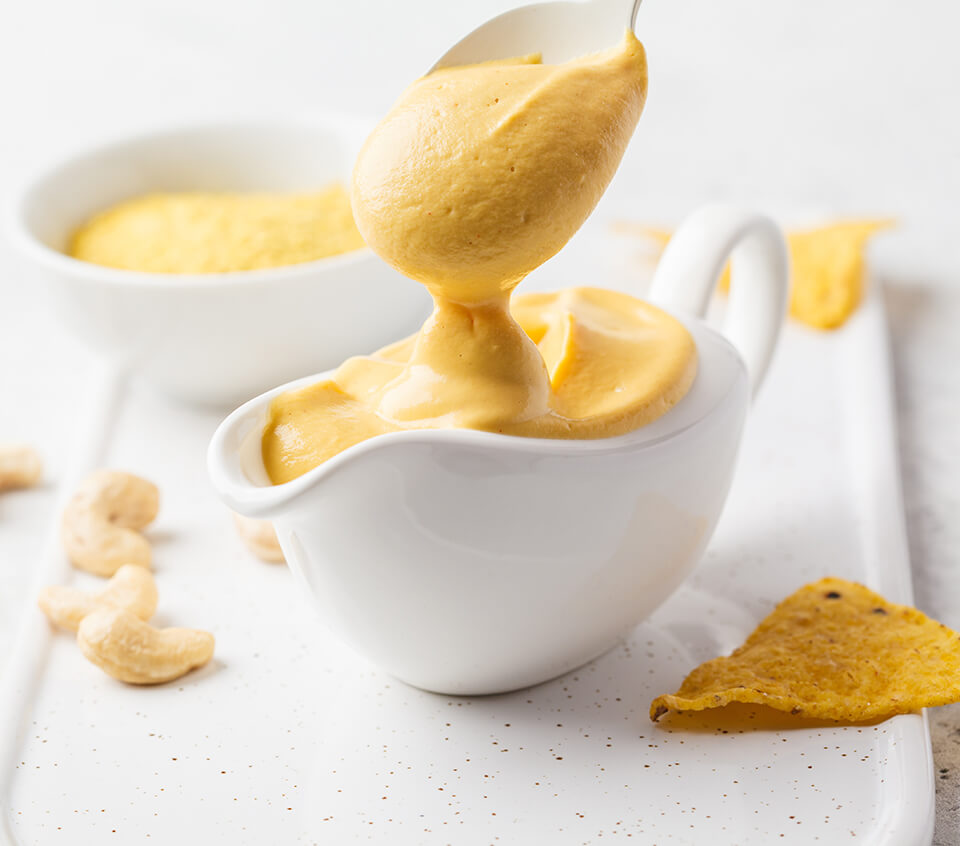 Hannah Sunderani's recipe for melty vegan cheese perect to use on pizzas and in grilled cheese photographed in a gravy boat