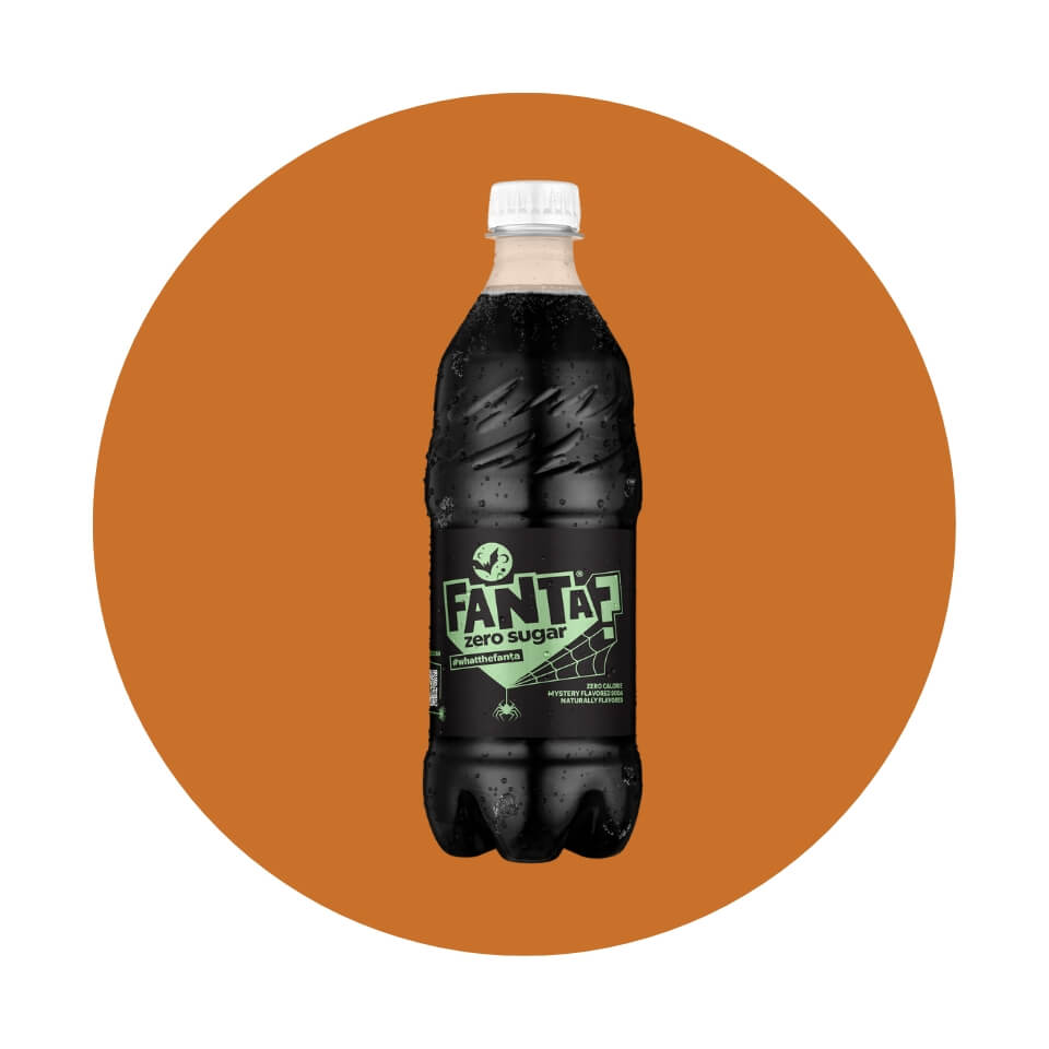 A black-and-green bottle of Fanta on an orange circle