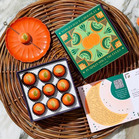 A wicker table with a box of pumpkin truffles