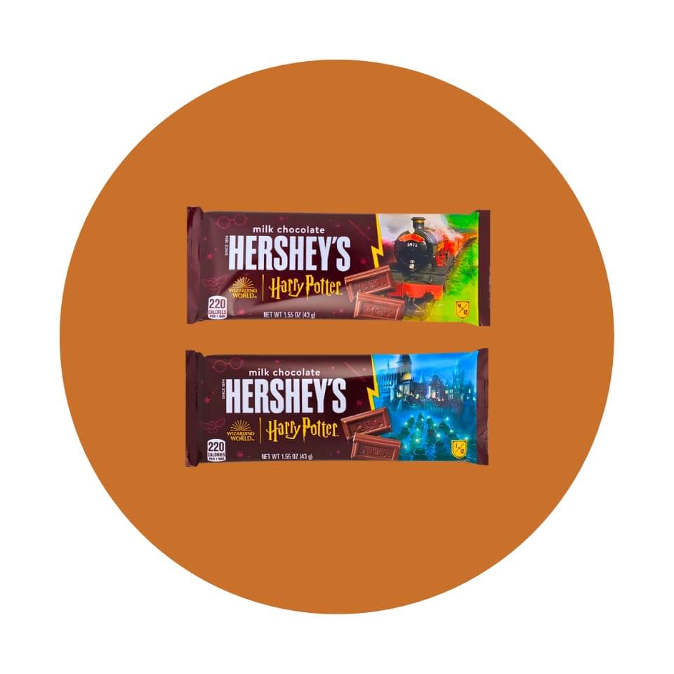 Two Hershey's chocolate bars with scenes from Harry Potter on them on an orange circle