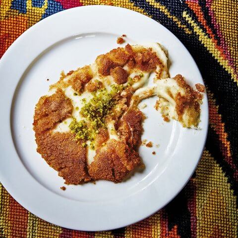 A dish of food on an embroidered background