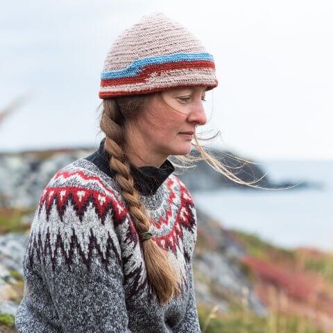 A woman in a wool sweater and hat