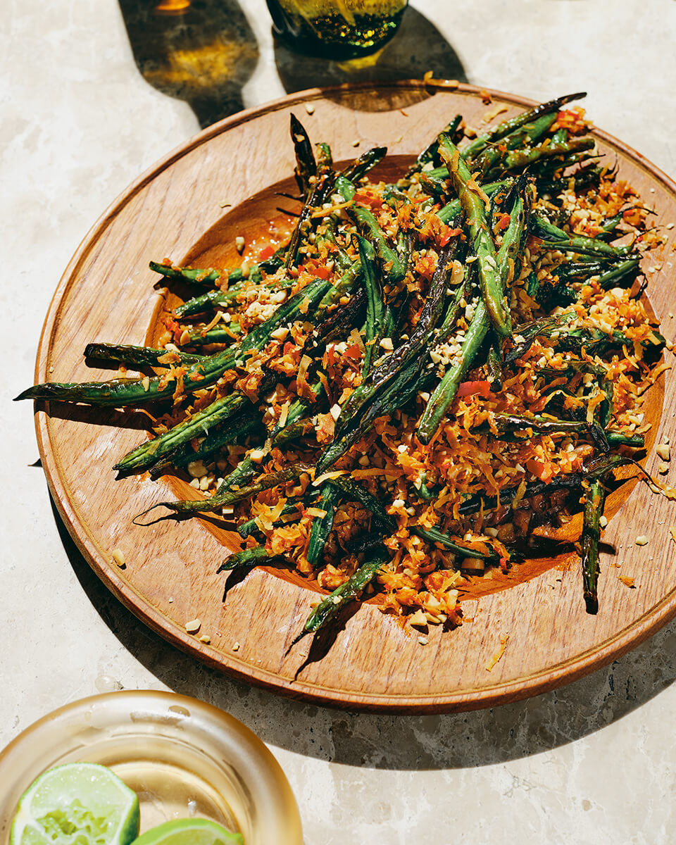A plate of green beans crusted with coconut flakes
