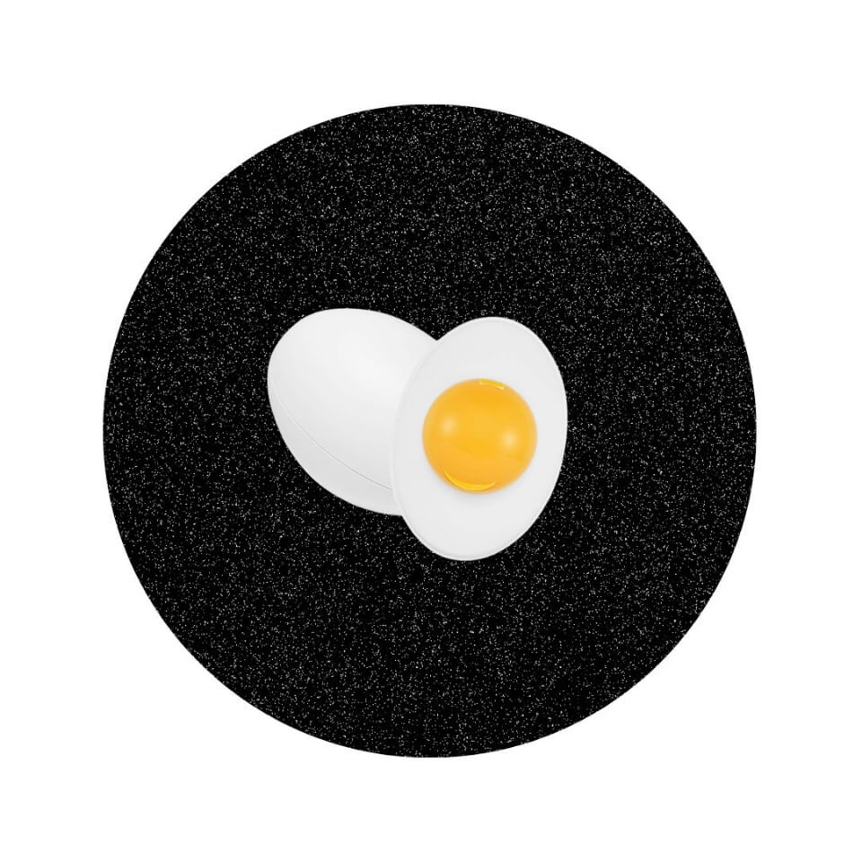 A plastic container shaped like an egg in a sparkly black circle