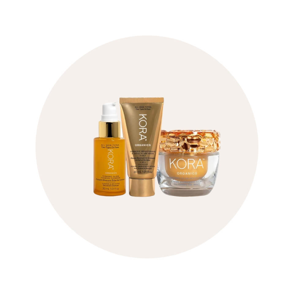 Three yellow-gold skincare products in a cream-coloured circle