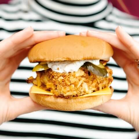 A woman holding a fish sandwich