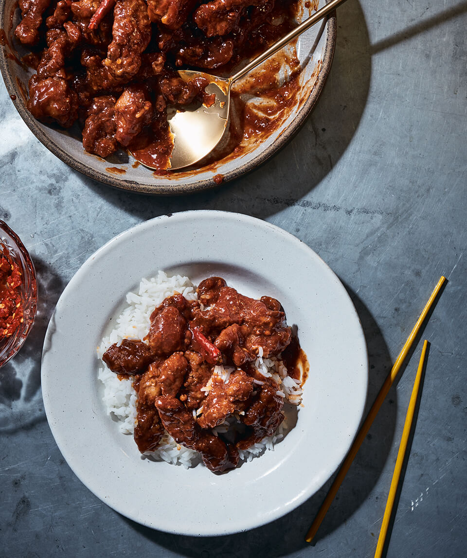 A serving dish with orange chicken and a dish of it over rice