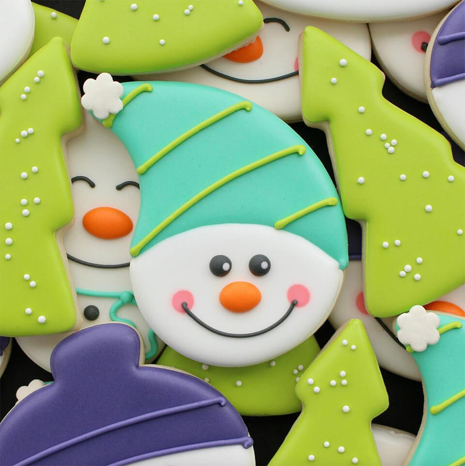 Cookies frosted like snowmen and Christmas trees