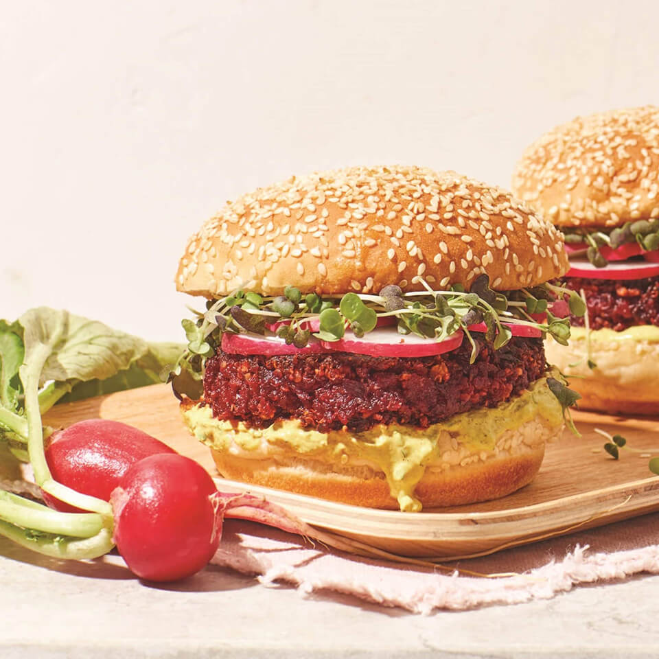 Veggie burgers with radishes next to them