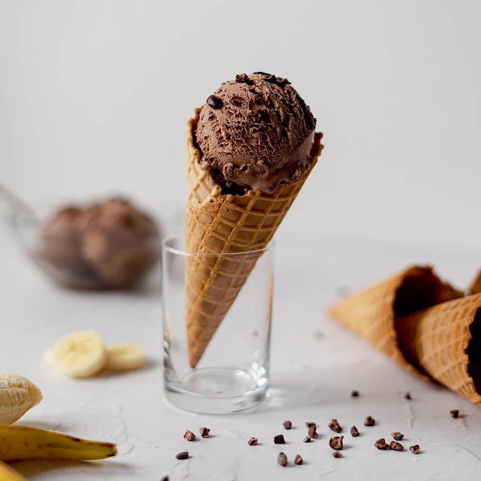A chocolate ice cream cone in a glass