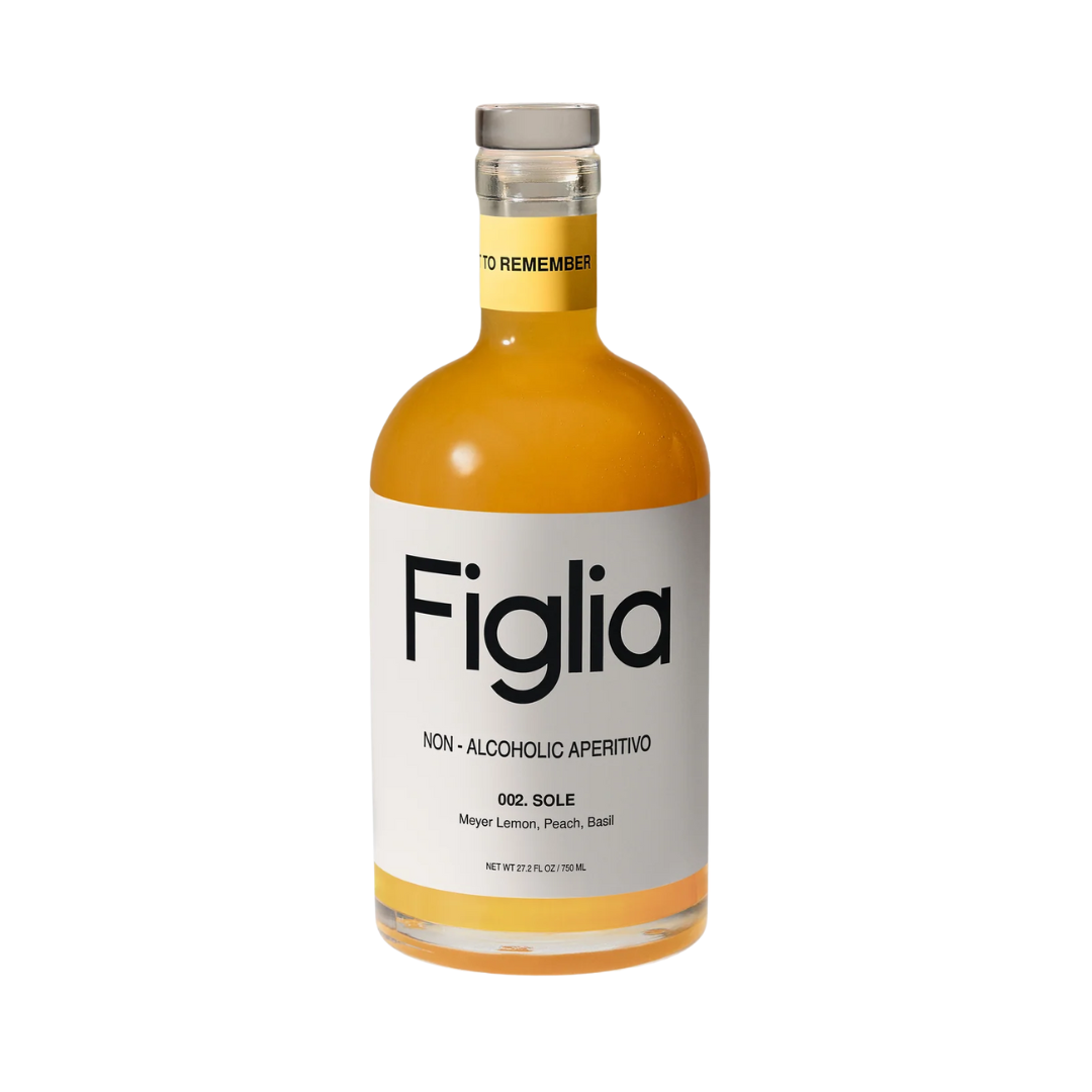 Clear bottle of bright yellow non-alcoholic aperitif. 