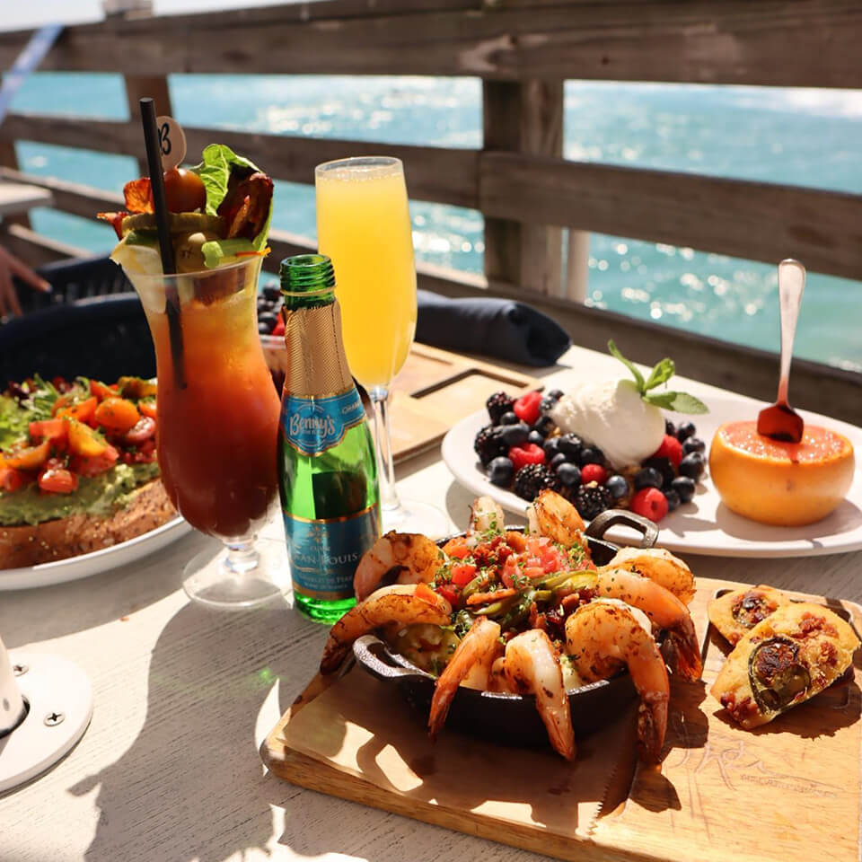 Brunch items on a table overlooking the ocean