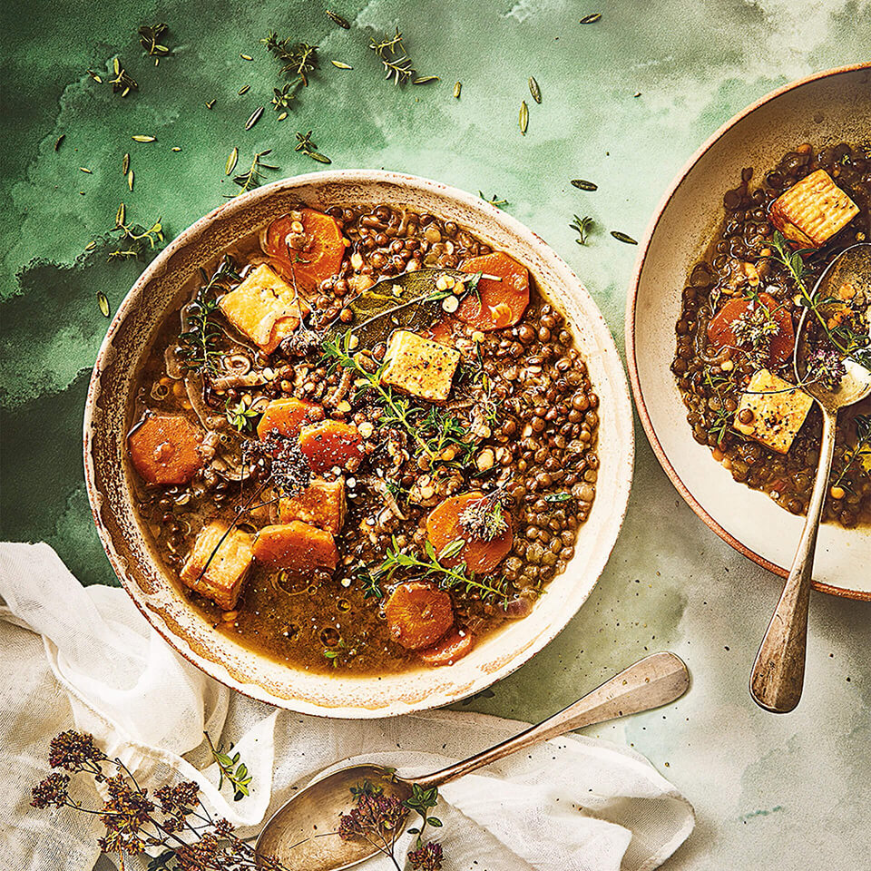 White bowls with lentil and tofu soup