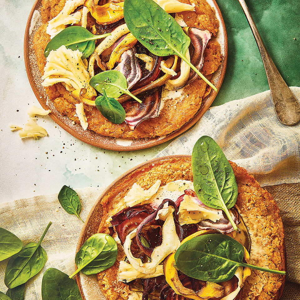 Miniature pizzas topped with various vegetables