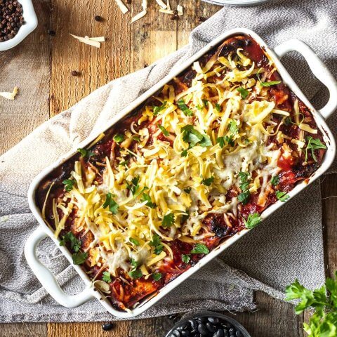 Butternut squash and black bean enchiladas baked in rich enchilada sauce