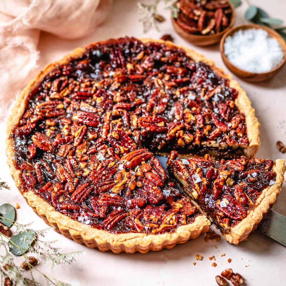 A pecan pie on a pink cloth