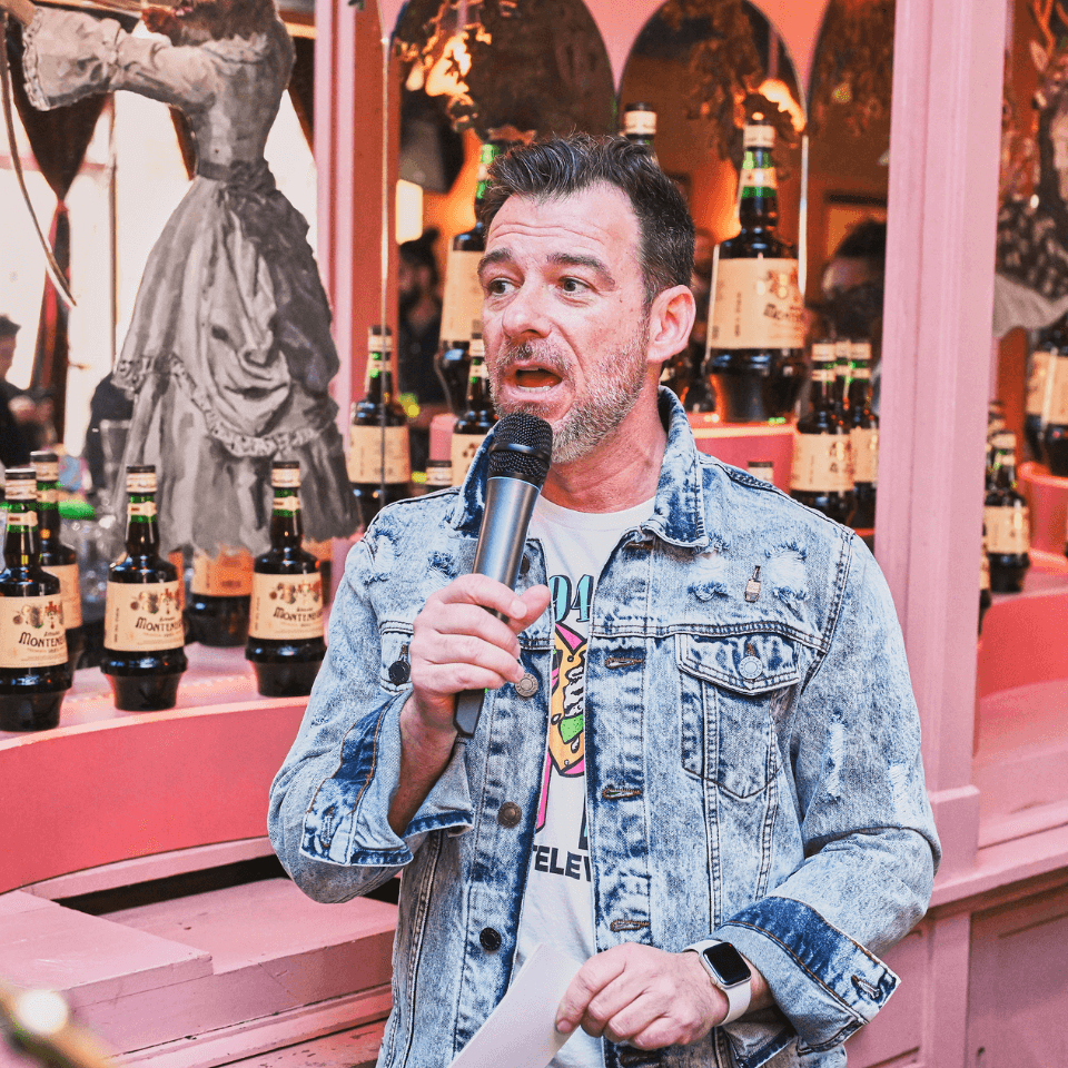 man in pink room with microphone