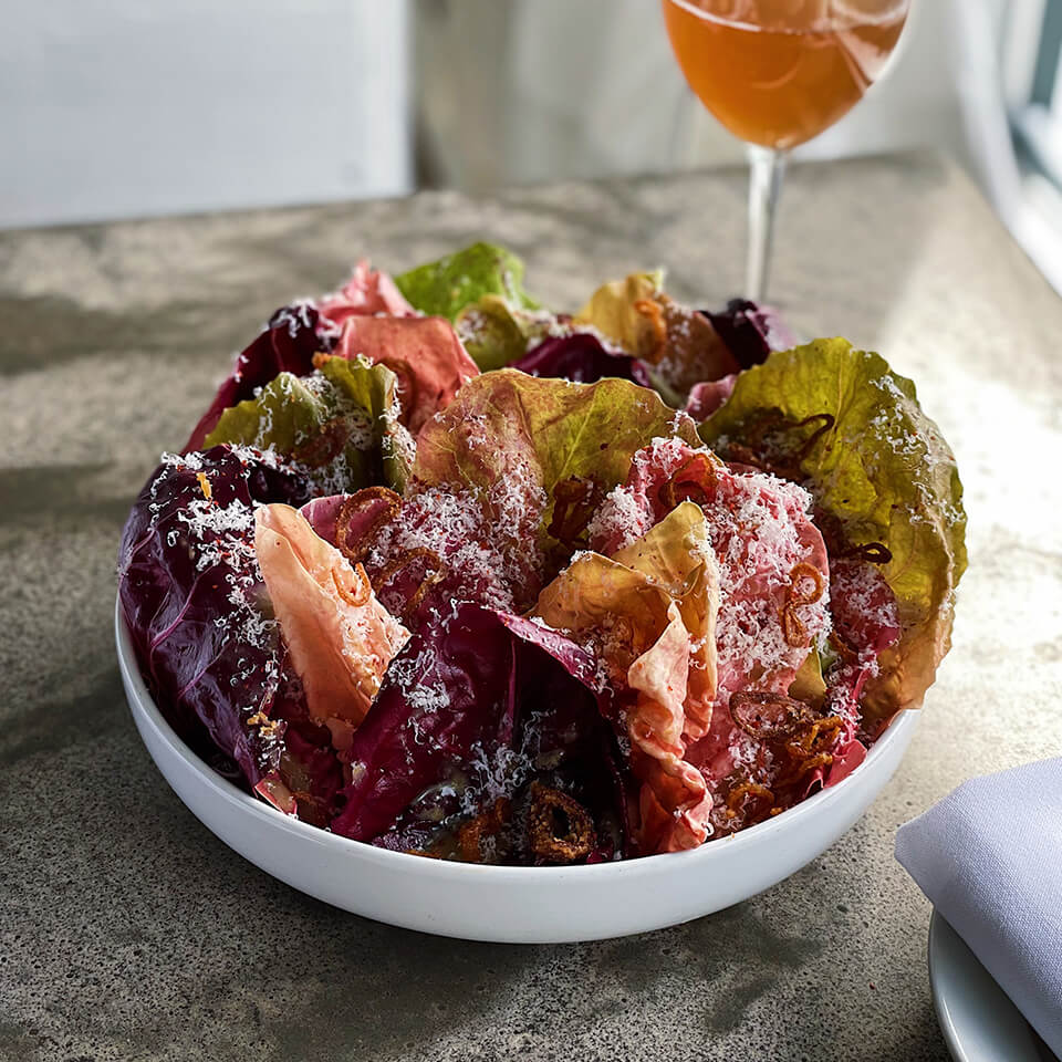 A white bowl with salad