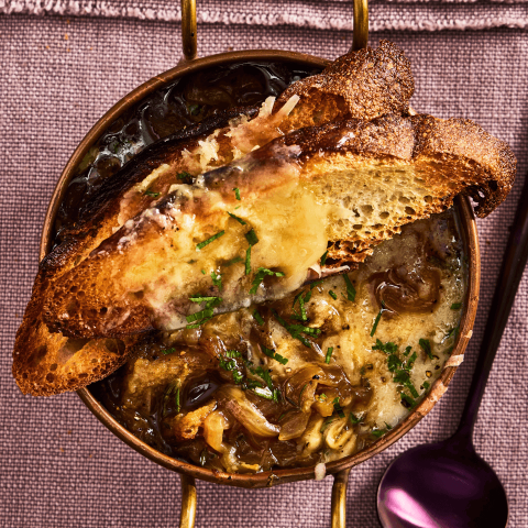 Rich, cheesy homemade French Onion Soup with a toasted baguette
