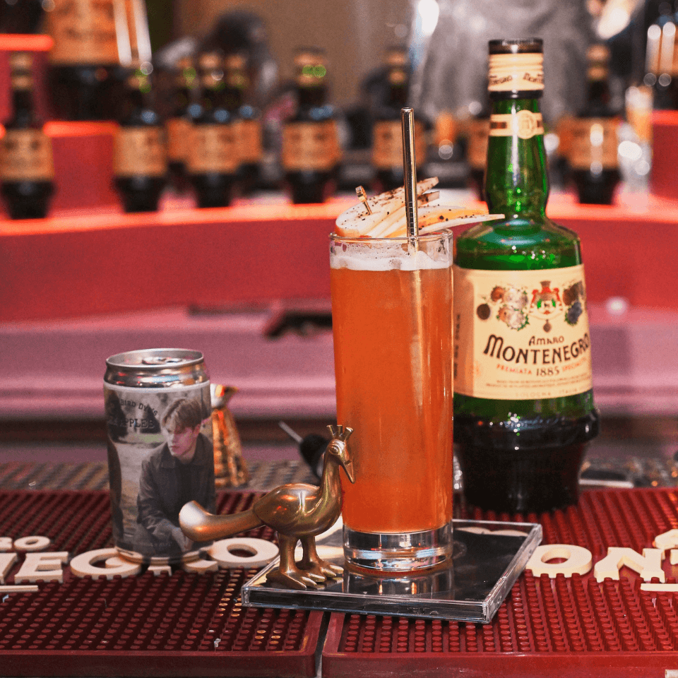 cocktail and bottle of Montenegro on bar