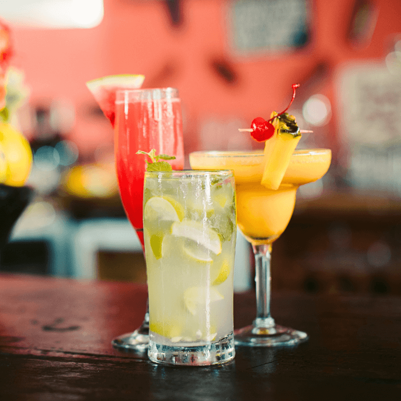 three cocktails on bar