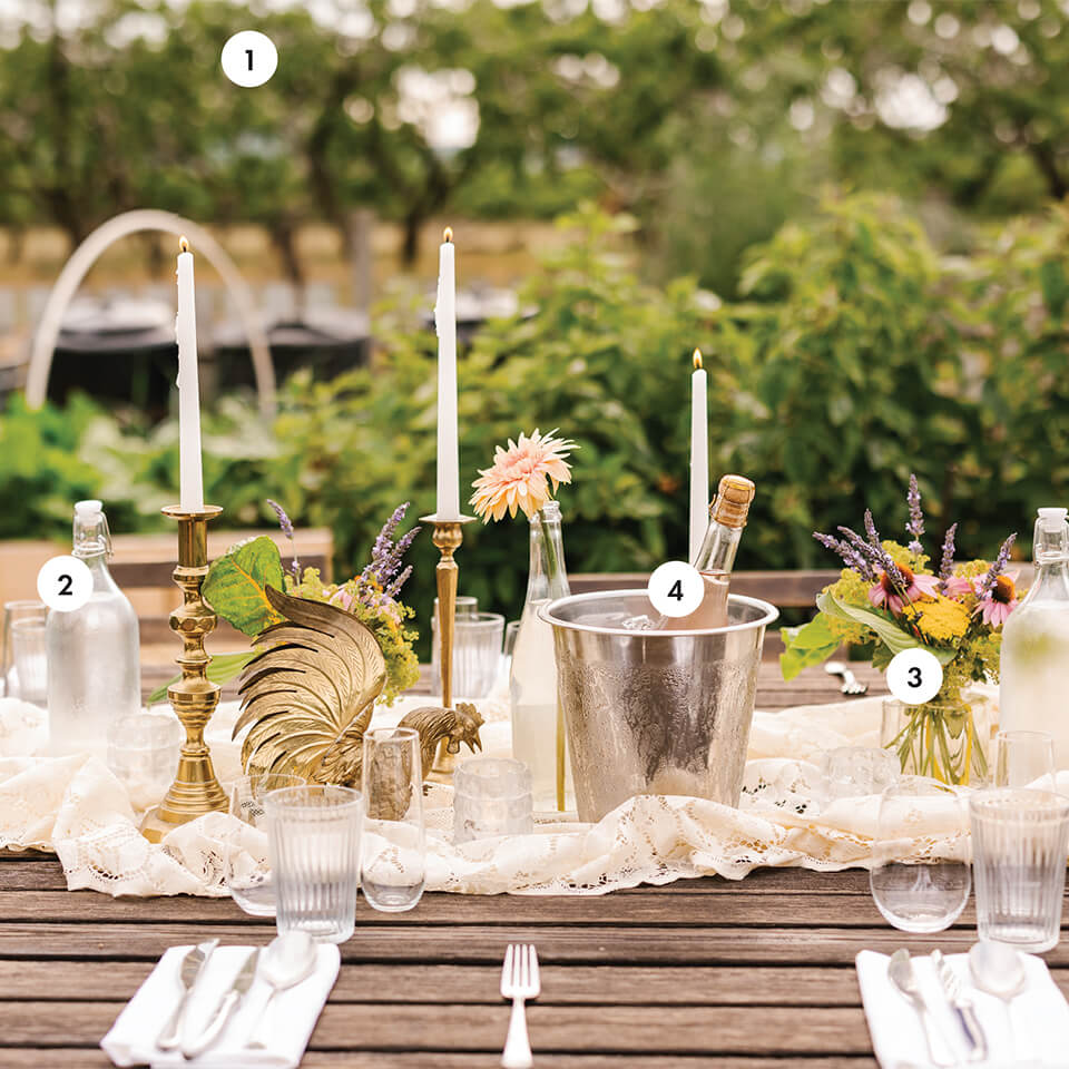Close-up of a styled al-fresco table with fresh herbs, rustic tableware