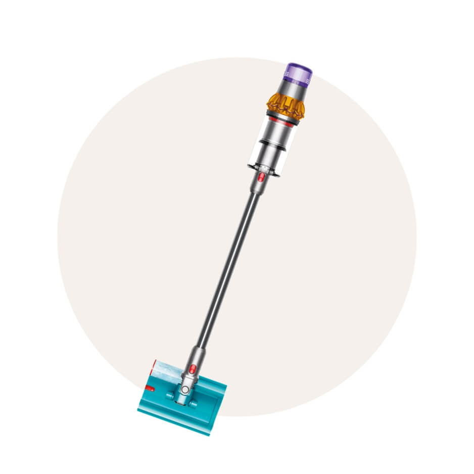 A Dyson vaccuum cleaner over a cream-coloured circle