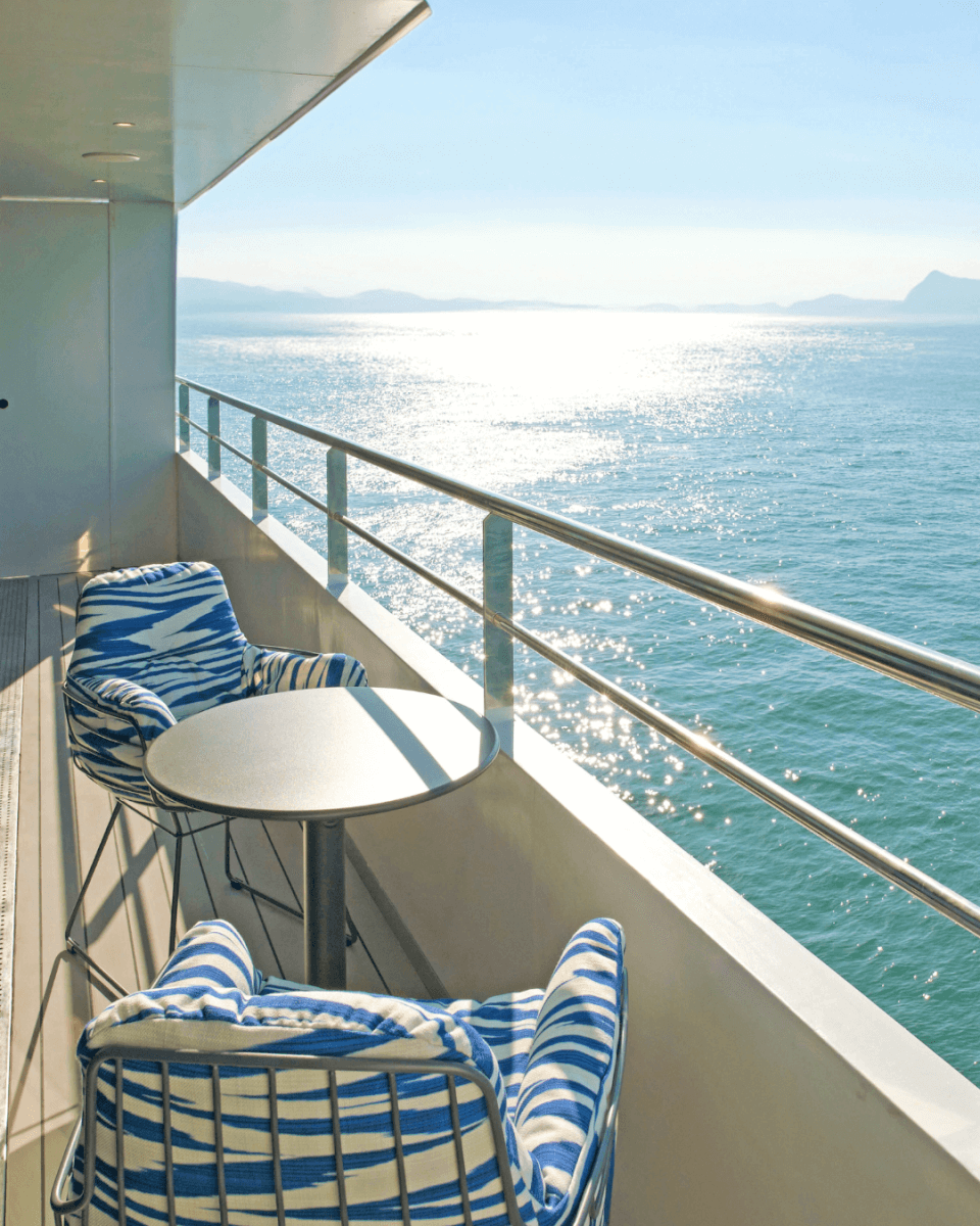 Balcony with two chairs looking over ocean