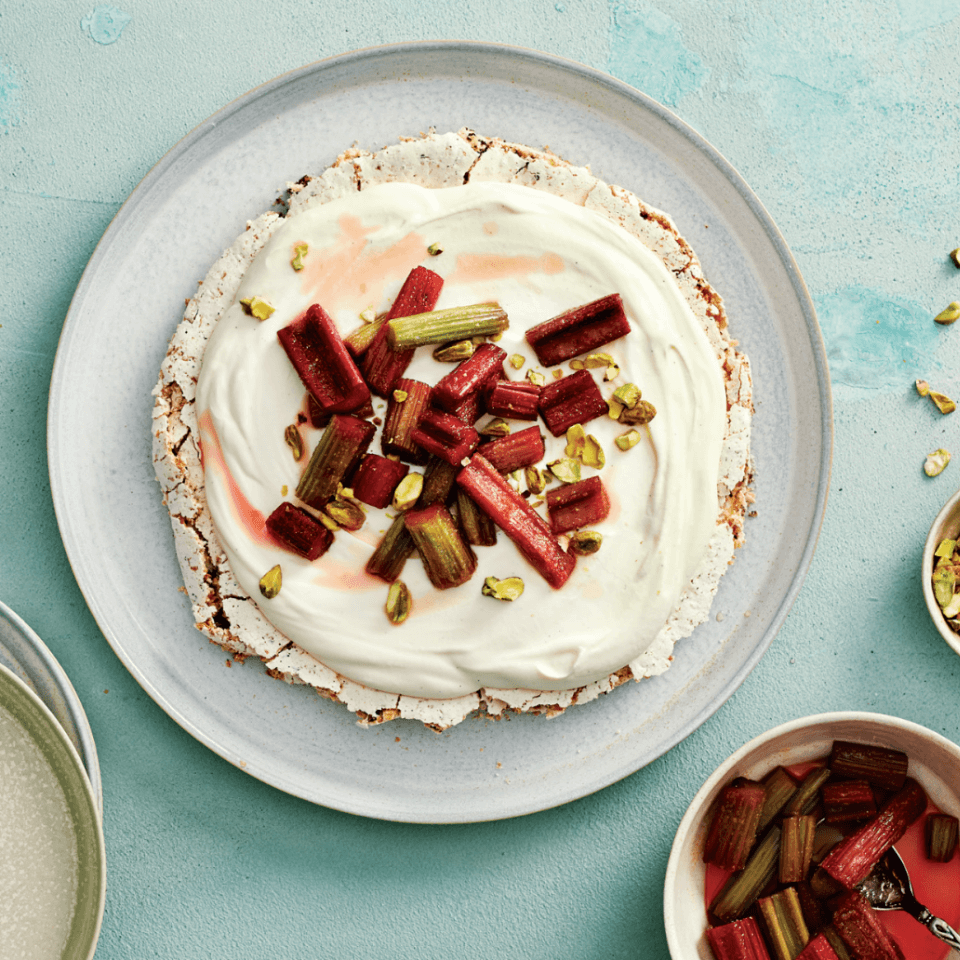 meringue dessert with whipped cream and rhubarb on it