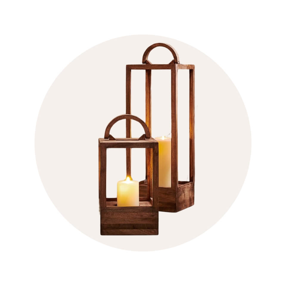 Two wooden lanterns with candles in a cream-coloured circle