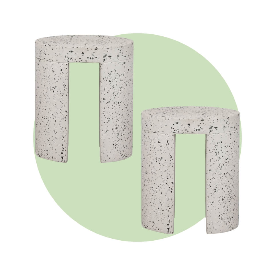 Two speckled concrete stools over a light green circle