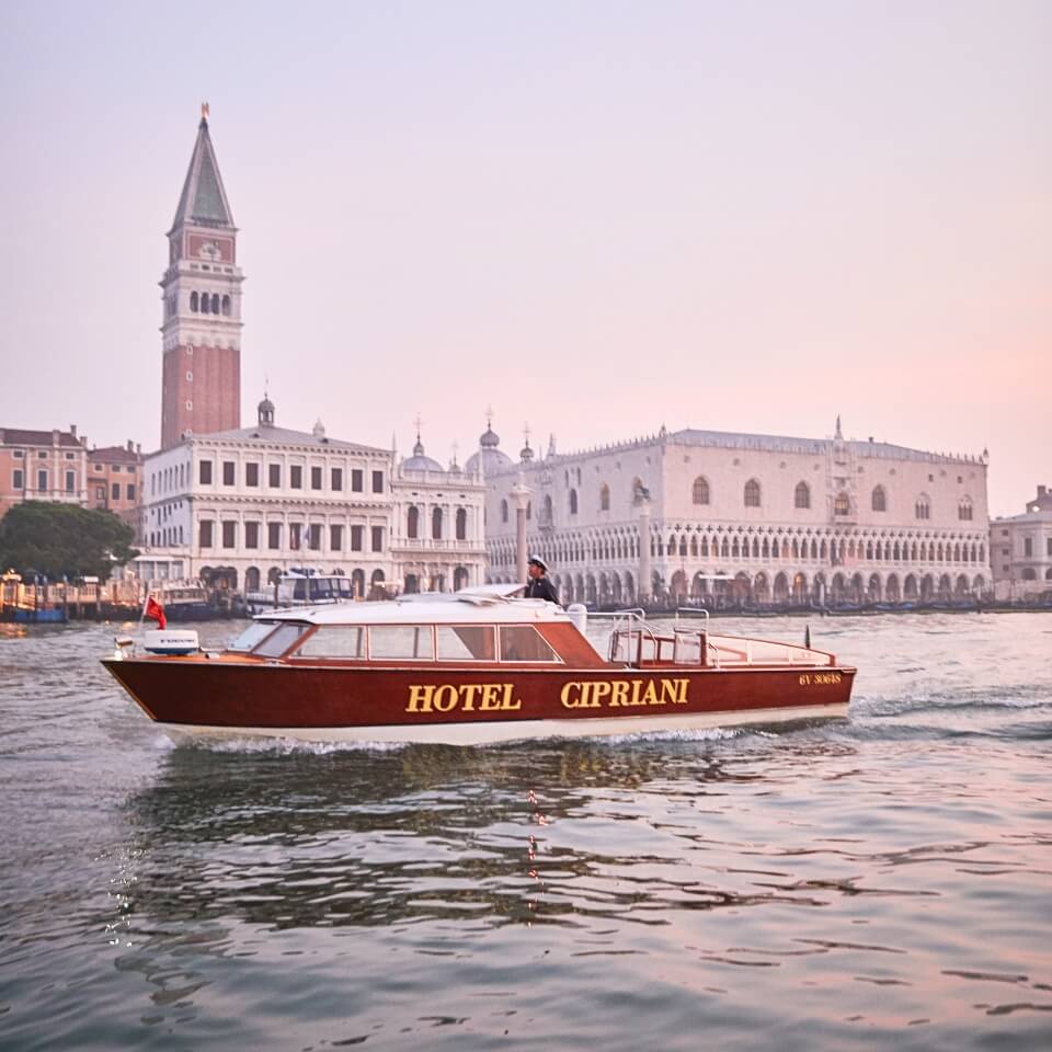 A boat with the words "Hotel Cipriani" in a canal