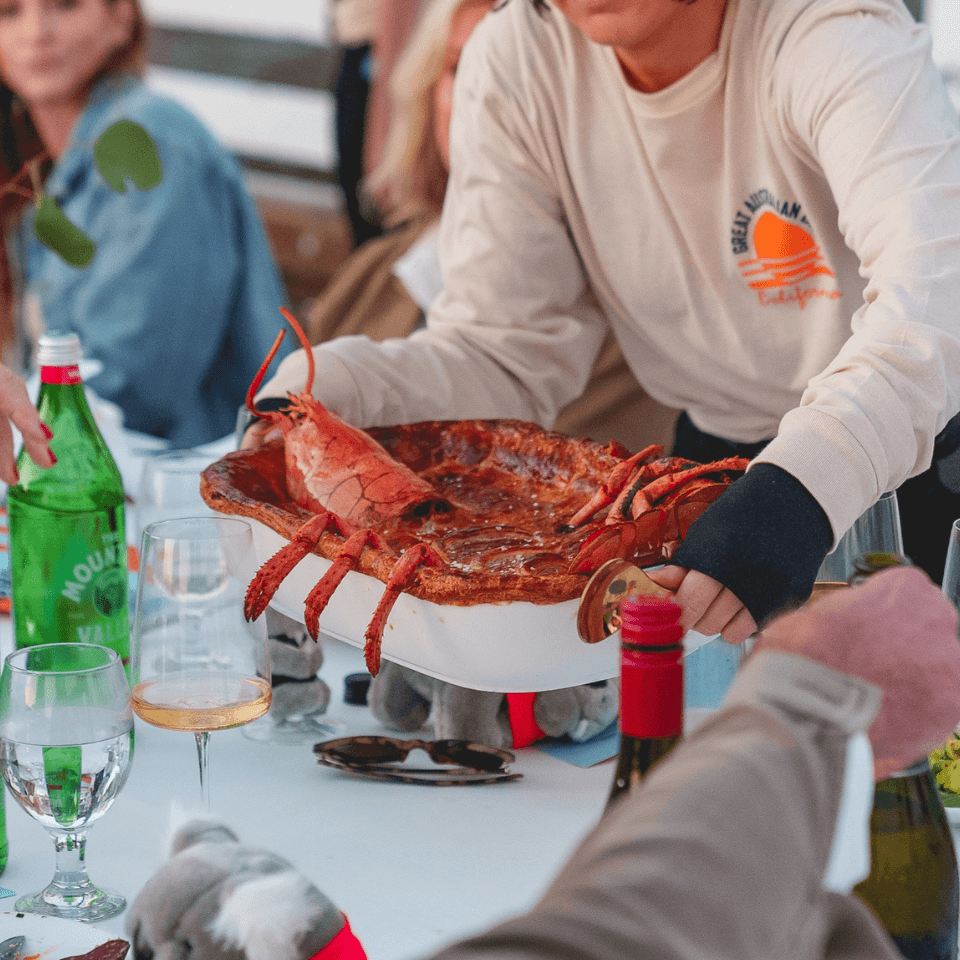 person serving pie with lobster