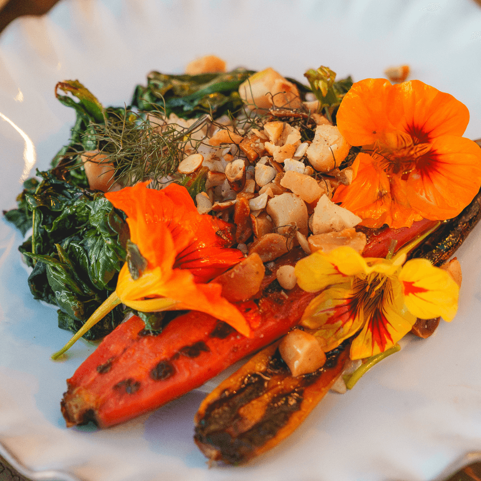 image of salad with nuts and nasturtium flowers