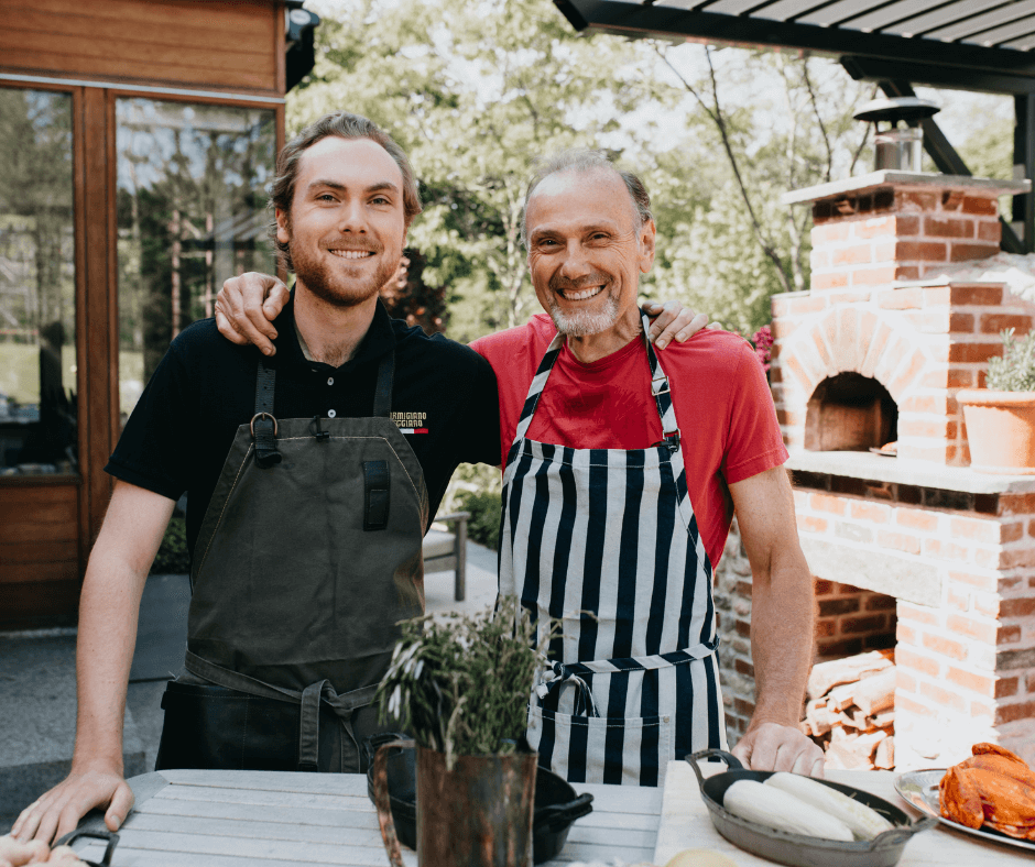 two men standing side by side outdoors