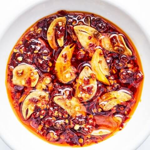 A white dish with chili crisp