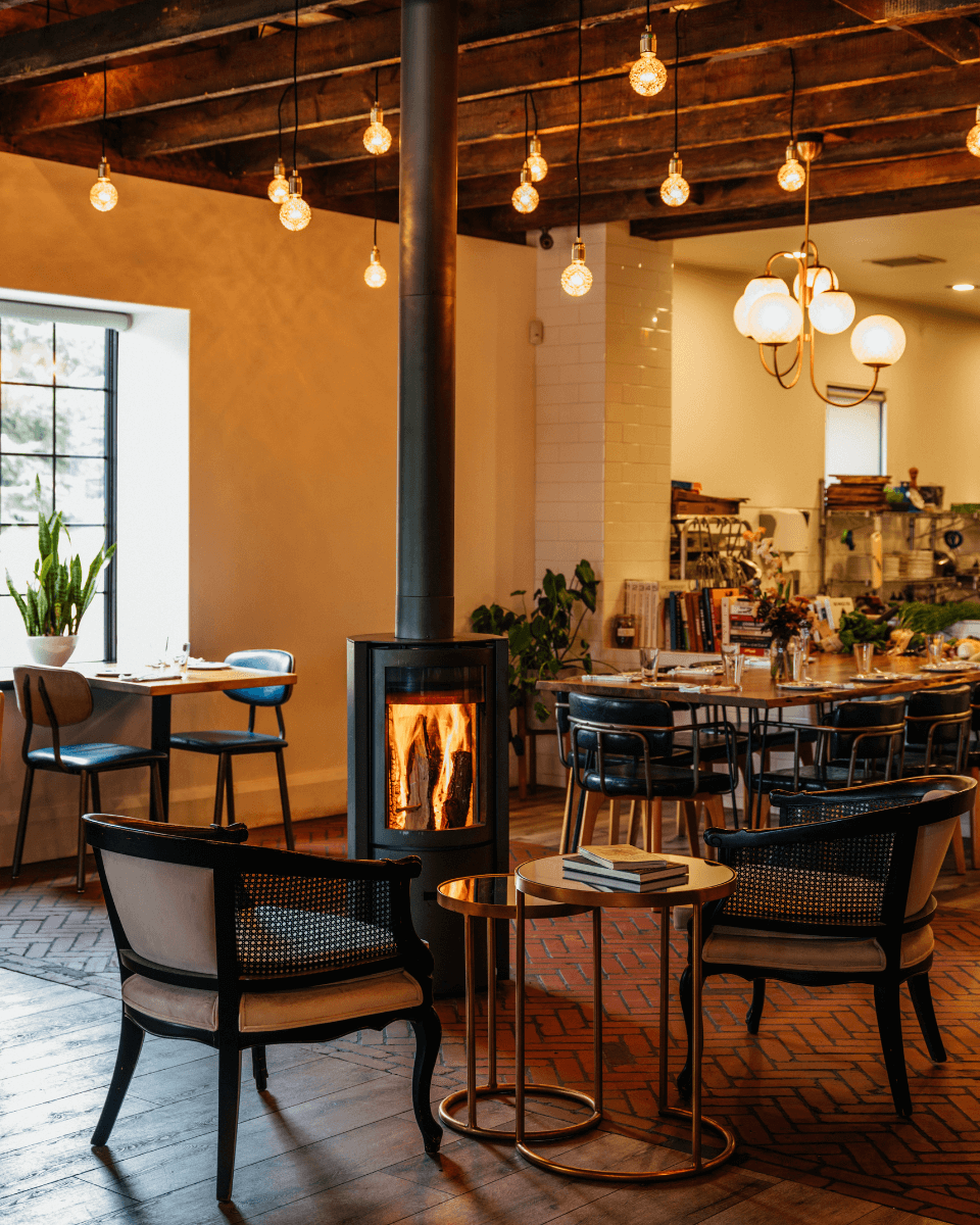 room interior with wood-burning stove and chairs and table