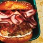 Gourmet pork burgers with pear and rum relish, smoked ham and mascarpone cheese spread on toasted brioche buns