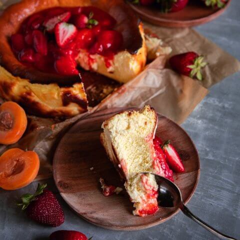 A slice of strawberry cheesecake on a plate