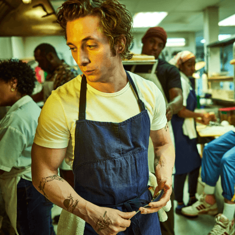 image of man in apron working in restaurant kitchen