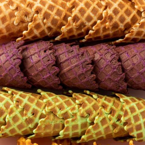 Four rows of waffle ice cream cones in different flavours