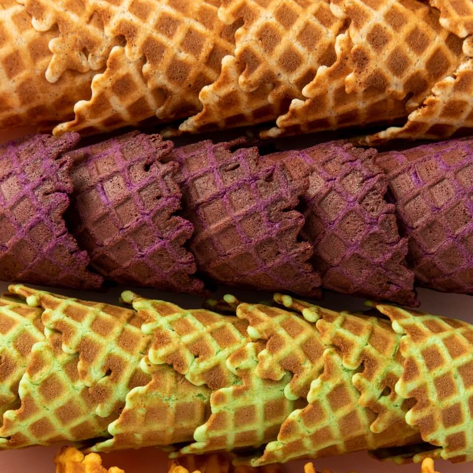 Four rows of waffle ice cream cones in different flavours