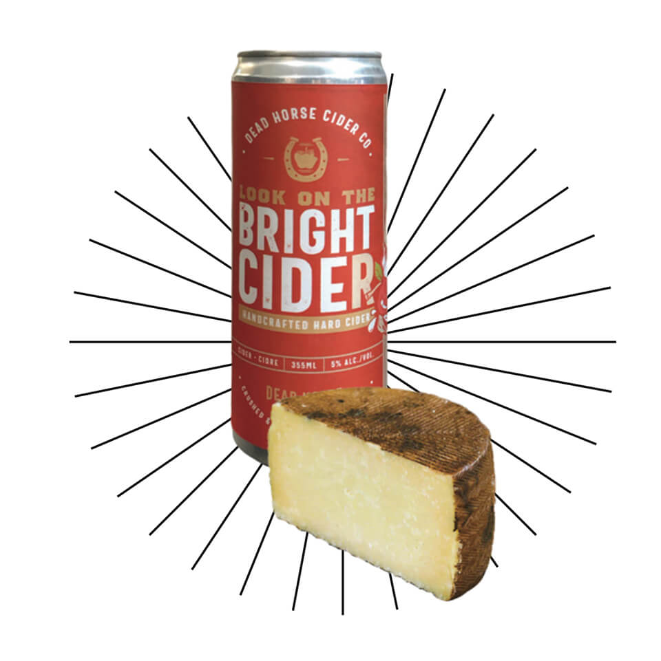 Can of Manitoba-made Look on the Bright Cider paired with half a wheel of Manchego cheese