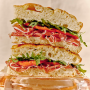 Prosciutto focaccia sandwich with arugula and tomatoes