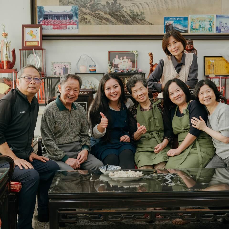 Seven family members posing in a living room.