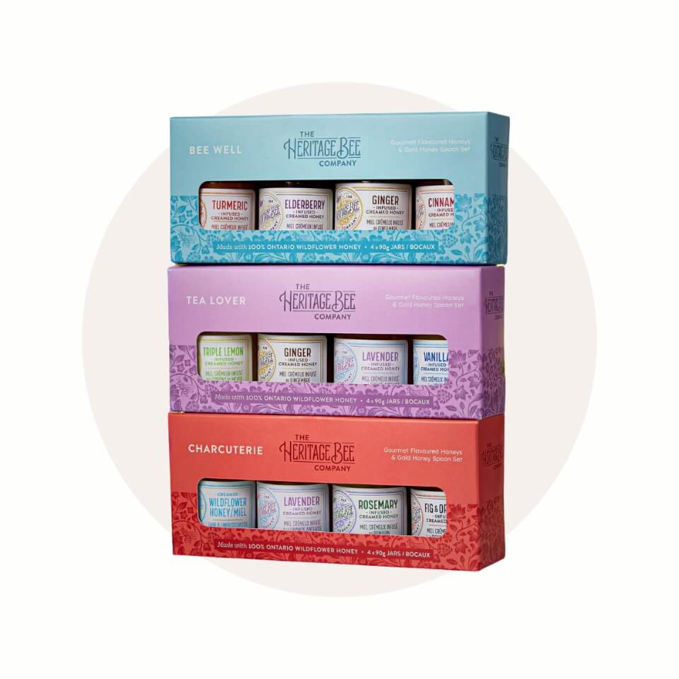 Three boxes, each containing four jars of honey, over a cream-coloured circle