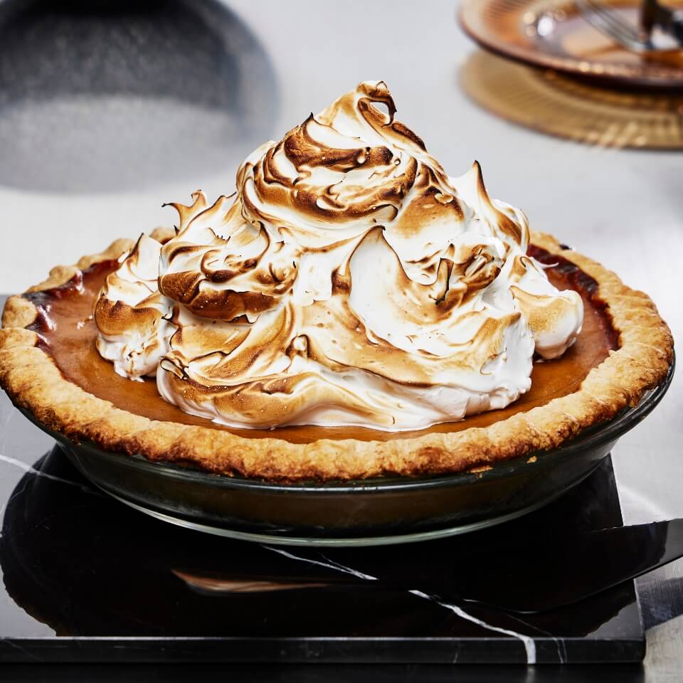A pumpkin pie topped with meringue